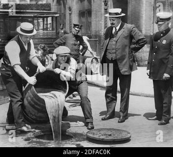 New York City stellvertretender Polizeikommissar John A. Leach, rechts, beobachtete Agenten, wie sie Alkohol in die Kanalisation nach Überfall während des Hochs der Prohibition einschütten, New York City, New York, USA, New York World-Telegram und The Sun Newspaper Photograph Collection, 1921 Stockfoto