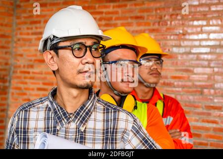 Teamarbeit Bau, Gruppenportrait von professionellen Ingenieur oder Architekt und Bauarbeiter auf der Baustelle. Stockfoto