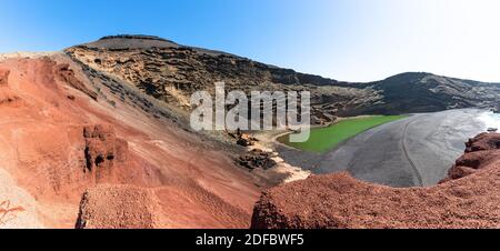 Einzigartiger Panoramablick auf den vulkanisch grünen See (El Lago Verde), den schwarzen Sandstrand und die imposanten erodierten Kraterwände des Vulkans in Schwarz, Grau und Rot. Stockfoto