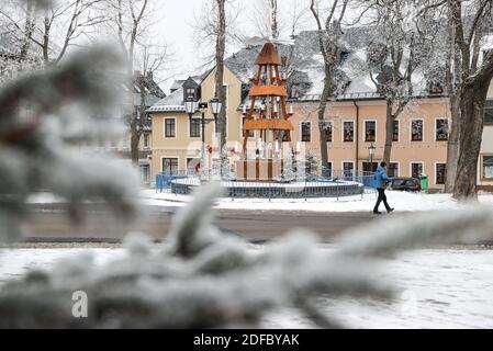 Oberwiesenthal, Deutschland. Dezember 2020. Ein Mann geht auf dem Markt. In keinem anderen Bundesland breitet sich die Coronapandemie derzeit so schnell aus wie in Sachsen. Daher sind jetzt strengere Maßnahmen in Kraft, einschließlich anfänglicher Beschränkungen. Alle Weihnachtsmärkte und Bergparaden sind abgesagt. Quelle: Jan Woitas/dpa-Zentralbild/ZB/dpa/Alamy Live News Stockfoto