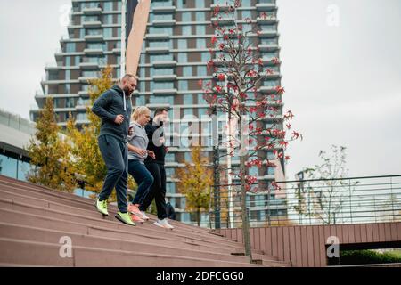 Drei junge Freunde laufen auf der Treppe Stockfoto