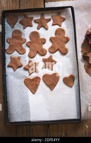 Rohe Lebkuchen schneiden Sterne, Herzen auf Backblech aus Stockfoto