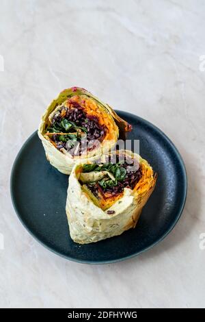 Vegetarisches Frühstück Burrito mit Wild Rice / Schwarzer Reis, Avocado, Kale, Hummus und Karotte. Gesundes Fast Food. Stockfoto