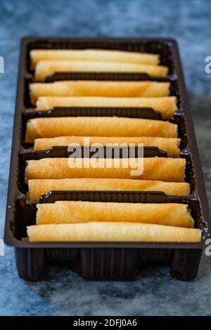 Krumkake. Tschechische Pirouette Kekse (Parizske Pecivo). Hergestellt mit einem Teig wie Pfannkuchen Teig, Wafer Cookies gibt es in Kunststoff-Container Stockfoto