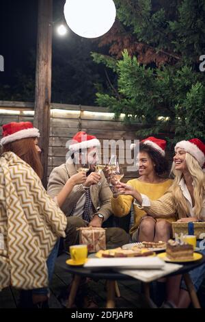 Gruppe von jungen erwachsenen Freunden toasten, Weihnachten feiern Stockfoto