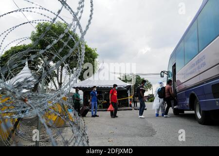 Selangor, Malaysia. Dezember 2020. Arbeiter, die für COVID-19 positiv getestet wurden, steigen in einen Bus zum Hosptial in Klang des Staates Selangor, Malaysia, 5. Dezember 2020. Die malaysische Regierung sagte am Samstag, dass sie die Bewegungskontrollordnung in mehreren Bereichen bis zum 20. Dezember verlängern wird, um die Ausbreitung von COVID-19 zu kontrollieren. Am Samstag meldete das malaysische Gesundheitsministerium 1,123 neue bestätigte COVID-19 Fälle, womit die nationale Gesamtzahl auf 71,359 angesetzt wurde. Quelle: Zhu Wei/Xinhua/Alamy Live News Stockfoto