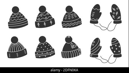 Glyph schwarz gestrickte Hüte, Fäustlinge Set. Kuschelige Winter-Kopfbedeckung mit Bommel. Saisonale Weihnachten warme Kleidung. Hygge Zeit, Urlaub niedlich Accessoire. Kappen für die kalte Jahreszeit. Isoliert auf weißer Vektorgrafik Stock Vektor