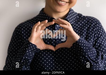 Glückliche junge Frau legte Finger in Herzform ausdrücken Liebe Stockfoto