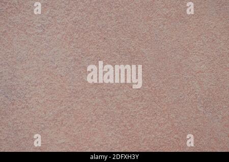 Eine flache, grob gearbeitete Oberfläche eines natürlichen braunen Steins mit gesprenkelter Textur. Hintergrund, Textur. Stockfoto