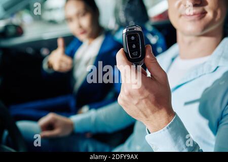 Mann, der die Autoschlüssel zeigte Stockfoto