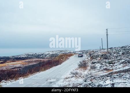 Winter Teriberka. Rutschige arktische Straße durch die Hügel. Stockfoto