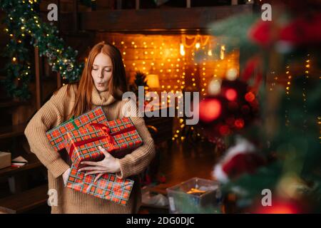 Portrait von glücklichen überrascht Frau fallen Geschenkboxen mit Weihnachten Geschenke in Bastelpapier verpackt Stockfoto