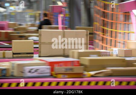 Ottendorf Okrilla, Deutschland. Dezember 2020. Pakete liegen auf einem Förderband im DHL Paketcenter. In der Zeit vor Weihnachten nimmt das Paketvolumen deutlich zu. (Aufnahme mit langer Verschlusszeit) Quelle: Robert Michael/dpa-Zentralbild/dpa/Alamy Live News Stockfoto