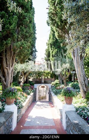 Der atemberaubende Garten der Villa Eva in der Stadt Ravello Italien. Ein renommierter Veranstaltungsort für Hochzeiten und eine Villa in Privatbesitz. Von Bäumen gesäumte Gartenpfad Luxus-Villa. Stockfoto