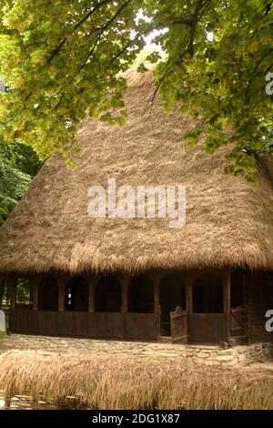 Dorfmuseum, Bukarest, Rumänien. Authentisches Haus aus dem 19. Jahrhundert aus Alba County mit schöner Holzveranda und Strohdach. Stockfoto