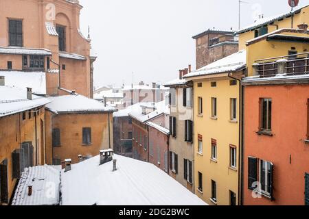 Schnee fällt auf die Dächer der bunten Häuser in der Altstadt von Bologna, Italien Stockfoto