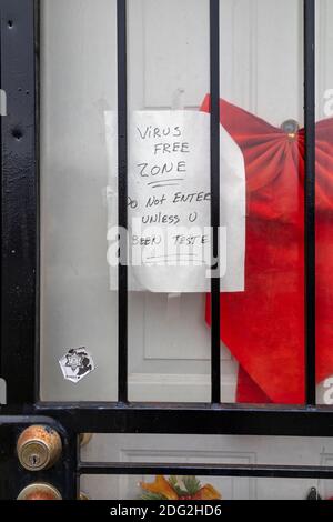 Detroit, Michigan, USA. Dezember 2020. Ein Schild neben einem Weihnachtsband an der Tür eines Geschäftsbereichs verkündet eine „virusfreie Zone“. Kredit: Jim West/Alamy Live Nachrichten Stockfoto