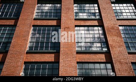 Vorderansicht Fenster eines restaurierten historischen Schuhwarehouse Backsteingebäude, umgewandelt in eine ältere Wohnung. Stockfoto