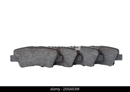 Satz Bremsbeläge Asbest-Legierung Fahrzeug Ersatzteile liegen in einer Linie isoliert auf einem weißen Hintergrund mit Kopieplatz, niemand. Stockfoto