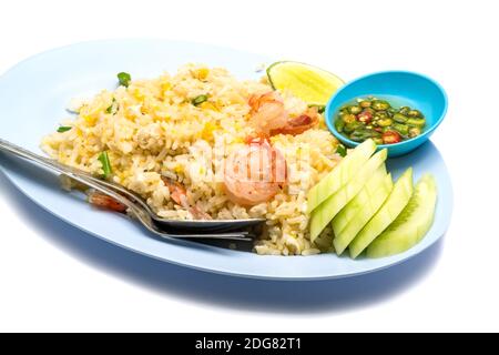 Gebratener Reis mit Ei, Gurke, Zitrone, Chili und Fischsoße auf einem blauen Teller Stockfoto