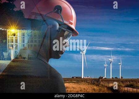 Männlicher Ingenieur in Harthut im Feld mit Windenergieanlagen Stockfoto