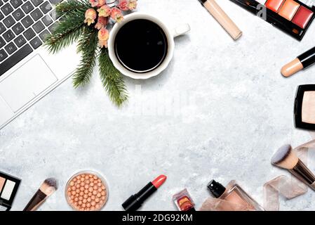 Dekorative Kosmetik- und Make-up-Werkzeuge auf Marmorhintergrund mit Laptop. Weihnachten Online-Shopping-Konzept. Frame-Komposition mit Kopierbereich. Flach liegend Stockfoto