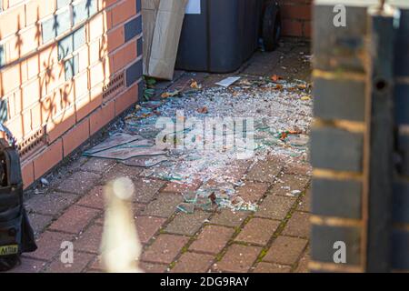 Zertrümmerte Glas aus dem Fenster, auf dem Mauerwerk Stockfoto