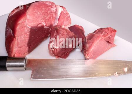 Runde Roastbeef Auge, italienische Fassona Rasse von Rindfleisch geschnitten mit Messer auf Schneidebrett Stockfoto