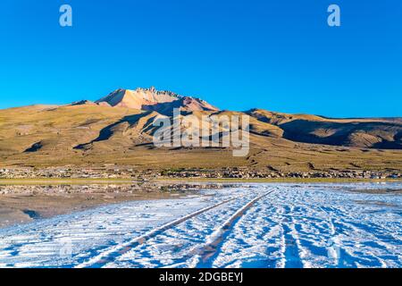 Blick auf den schlafenden Vulkan Tunupa und das Dorf Coqueza in der Uyuni Salt Flat Stockfoto