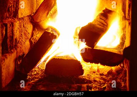 Kamm der Flamme auf brennendes Holz im Kamin. Nahaufnahme des Feuers im heißen Ofen Stockfoto