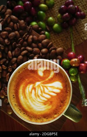 Ansicht eines Cappuccinos mit rohem und geröstetem Kaffee von oben Bohnen Stockfoto