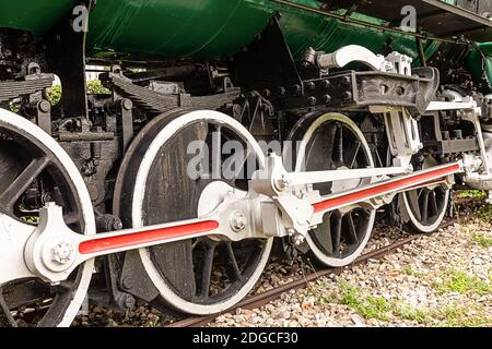 Die Räder der Lokomotive sind groß schwarz mit weiß Felgen stehen in den Gleisen Stockfoto