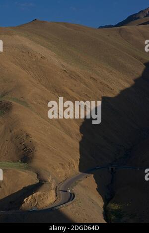 Auto auf der Autobahn. Morgensonne beleuchtet den Straßenrand auf der Leh zu Srinagar Autobahn nahe dem Fotu-la-Pass, Ladakh, Jammu und Kashmir, Indien Stockfoto