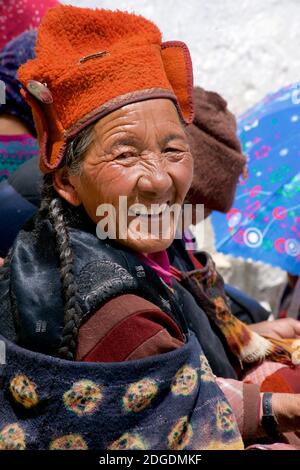 Dorfbewohner in traditioneller Ladakhi-Kleidung. Karsha Gustor Festival, Karsha Kloster, in der Nähe von Padum, Zanskar Valley, Ladakh, Jammu und Kaschmir, Nordindien. Traditionelle Yak-Wolle, gebundener Schal und Hut, wobei letzterer ein Foto des Dalai Lama auf einem Abzeichen trägt. Stockfoto