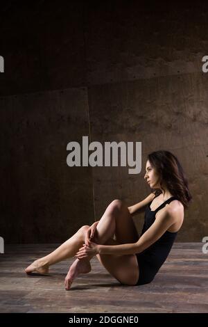Abstrakt und Stress emotionales Konzept. Depressive Mädchen in einsamer Stimmung, Thema von Stress. Traurige Frau, die allein im leeren Raum sitzt. Stockfoto