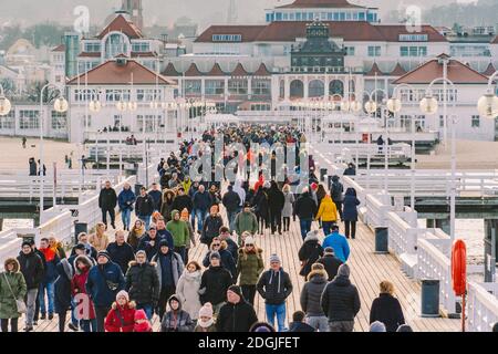 Eine Menschenmenge spaziert am 20. Juli 2020 an einem sonnigen Wintertag in der Nähe der Ostsee auf einem Holzsteg in Sopot, Polen. Wint Stockfoto