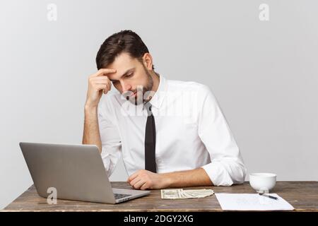 Unglücklicher Mann, der im Büro arbeitet, auf die Kamera schaut, Vorderansicht, isoliert auf Weiß. Stockfoto