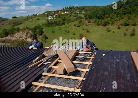 Bauarbeiter, der ein neues Dach installiert Stockfoto