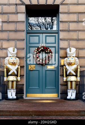 Detail der traditionellen Weihnachtskranz und große dekorative Statuen vor der Haustür in New Town of Edinburgh, Schottland, Großbritannien Stockfoto