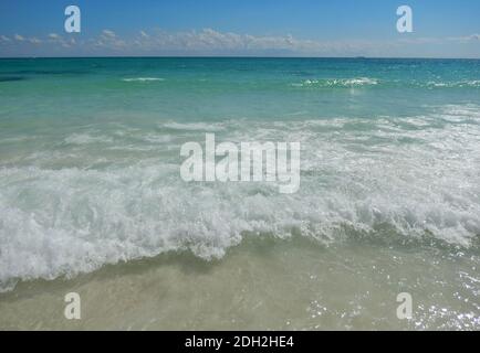 Klarer Himmel über einem weißen Sand karibischen Strand mit Wellen am Atlantik in Cancun, Mexiko Stockfoto