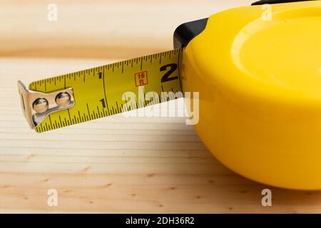 Maßband auf Holzoberfläche für Präzisionsaufgaben im Bau- und Heimwerkerbereich Stockfoto