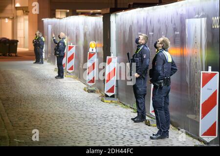 Hamburg, Deutschland. Dezember 2020. Polizisten stehen mit Maschinengewehren auf einer Straße und beobachten ein Bürogebäude. Wegen eines mutmaßlichen bewaffneten Raubüberfalls in der Hamburger Innenstadt ist die Polizei mit einem großen Kontingent eingezogen. Quelle: Jonas Walzberg/dpa/Alamy Live News Stockfoto