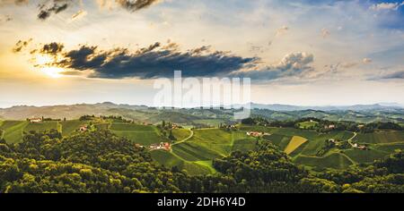 Herrlicher Sonnenuntergang über schönen grünen Weinbergen. Luftpanorama Sonnenuntergang über österreichischen Traubenhügeln im Sommer. Stockfoto