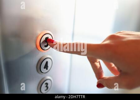 Womans Hand drücken Taste des Aufzugs zum fünften Stock Nahaufnahme Stockfoto