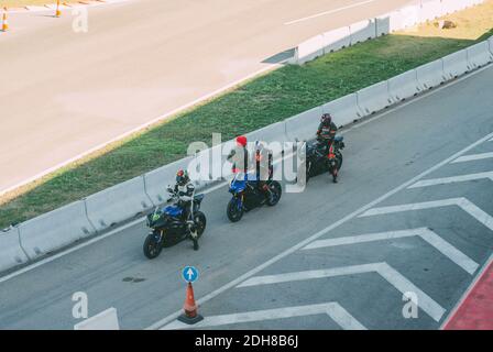 VALENCIA, SPANIEN - 07. Dez 2020: Vor dem Start des Rennens ziehen drei Motorradpiloten die Handschuhe an. Stockfoto