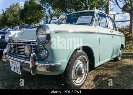 Close up front view of a 1962 Datsun Bluebird 1200 Deluxe P312 parked outside in sunshine Stock Photo