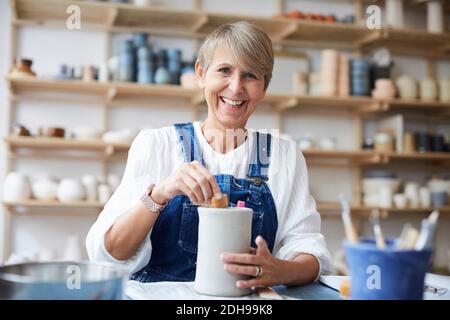 Portrait der lächelnden reifen Frau lernen Töpferei im Kunststudio Stockfoto