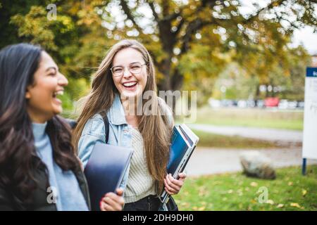 Glückliche junge Freundinnen auf dem Universitätscampus Stockfoto