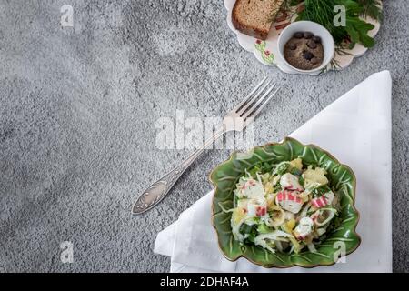 Salat aus Gemüse, grünen Zwiebeln und Krabbenstäbchen Stockfoto