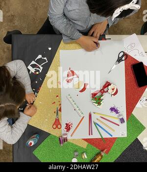 Ein Blick von oben auf die hispanische Frau und das Mädchen, die Weihnachten machen Basteln auf einem Tisch zu Hause Stockfoto